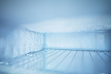 Empty open freezer in the refrigerator. - obrazy, fototapety, plakaty