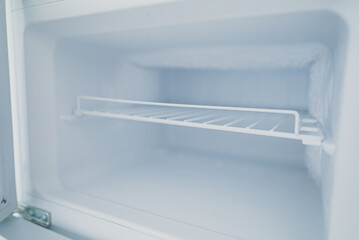 Empty open freezer in the refrigerator. - obrazy, fototapety, plakaty