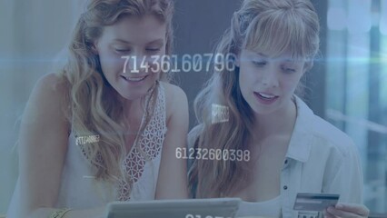 Animation of changing numbers over caucasian female friends shopping on laptop using credit card