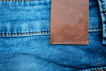 Blue Denim Jeans,belt,jeans pants with leather belt.label,sticker,tab,tag on the jeans.Empty blank space.closeup.Copy space.