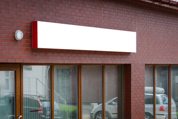 Blank white store entrance mockup, glass brick wall. Empty exterior signage on business center...