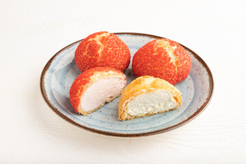 French custard dessert shu cake on white wooden, side view.