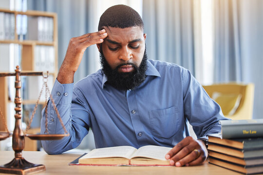Black man, lawyer and reading book with stress in office from worry, pain or frustrated with challenge of court case. Confused advocate, attorney and headache from legal research analysis in law firm