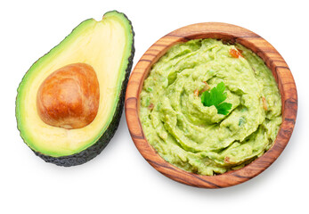 Guacamole and cross section of avocado fruit isolated on white background.