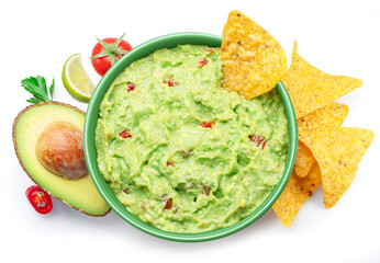 Guacamole sauce, its ingredients tortilla chips, popular Mexican food  top view on white background.