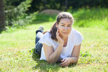 Woman lying on the lawn on a sunny warm day