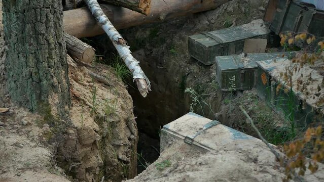 war in Ukraine abandoned Russian dugout after retreat
there are boxes of ammunition on the edges
stop the war
a deep trench fortified with logs