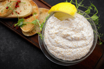 Pike caviar with toast on a wooden board, close-up