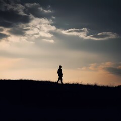 A silhouette of a lone figure walking against a contrasting background No 1