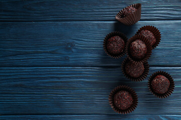 Brigadeiro on blue wooden background, space for text
