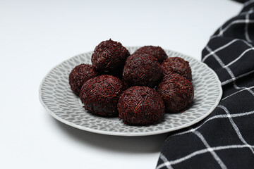 Brigadeiro in plate on white background, close up
