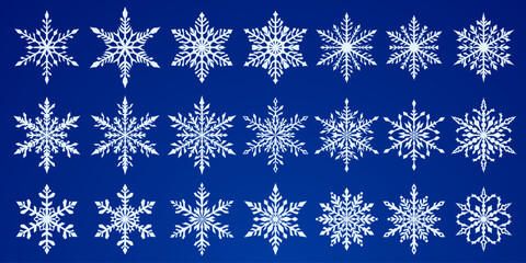 Set of beautiful complex Christmas snowflakes, white on blue background