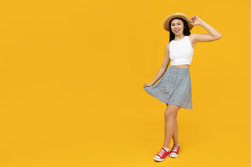 The Asian girl is dressed in summer clothes, with a straw hat