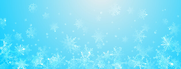 Christmas background of beautiful complex big and small snowflakes in light blue colors. Winter illustration with falling snow