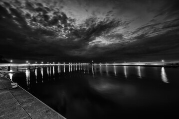 SUNSET - The colors of end of day on sea coast and breakwater of seaport
