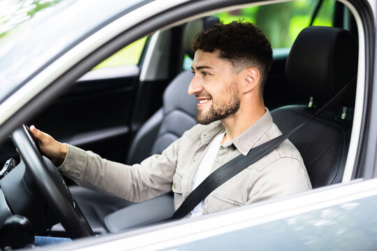 Young hispanic man driving car at street wear safe belt