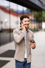 Young man talk on phone and walk on street