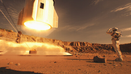 Two astronauts in spacesuits stand, watch spacecraft landing on Mars surface. Manned space mission on red planet. Technological advance of the future. Futuristic colonization and exploration concept.