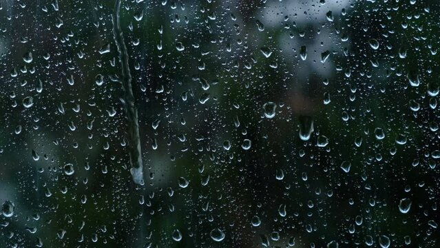 watching rain falling from window 