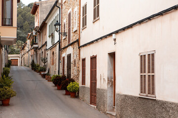 Fototapeta na wymiar View of a medieval street of the picturesque Spanish-style village Mancor de la Vall in Majorca or Mallorca island, Spain.