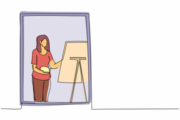 Single one line drawing woman painter drawing indoor near window. Female holding paint brush and palette, sketching on canvas. Artist painting at home. Continuous line draw design vector illustration