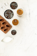 Top view of cold latte coffee with ice and coffee beans