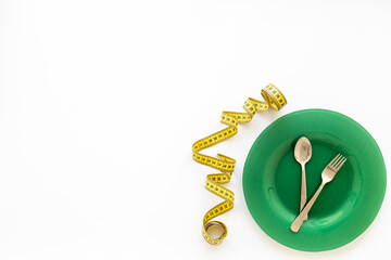 Body weight control concept with empty plate and cutlery, top view