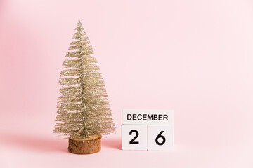 Christmas decoration and calendar with date December 26 on pink paper background with copy space,...