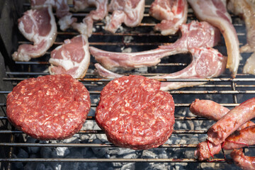 Two beef hamburgers, sausages and lamb chops, typical Spanish grill. Weekend menu to cook in a camping
