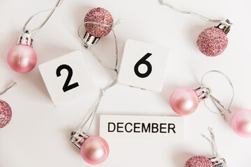 Boxing Day, wooden calendar with the date December 26 and decor on a white background. The concept of preparing for the Christmas and New Year holidays.