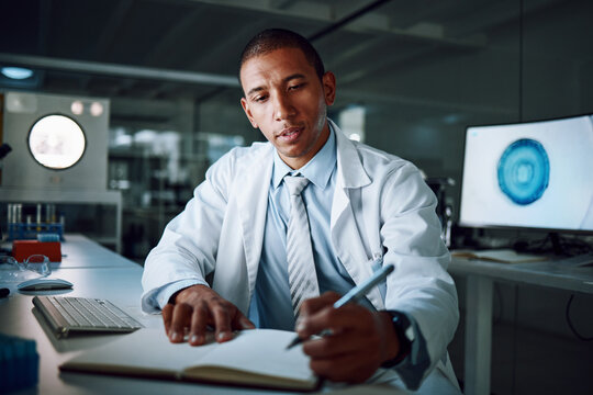 Doctor, writing and night in laboratory for medical research and study for healthcare report. Paperwork, African male professional and planning with data for biotechnology in a clinic or hospital
