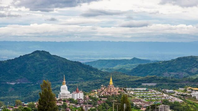 Time lapse of The landscape of Wat Phra That Pha Son Kaew with its five large white Buddha images is unique and features mountains, sky and rain clouds.