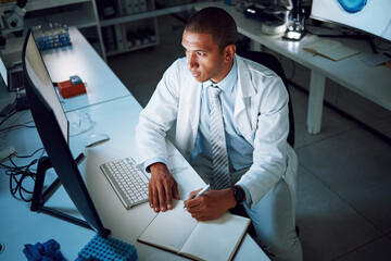 Doctor, writing and night with computer in laboratory for medical research and study with...