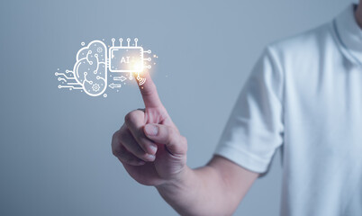 Businessman touching the brain working of Artificial Intelligence (AI), in the futuristic business coding software development on interface and synchronize network connection, innovative.