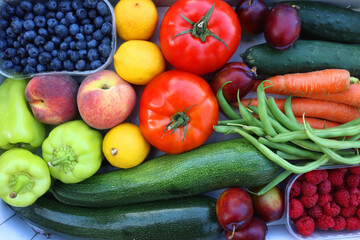 Wooden crate full of healthy colorful seasonal fruit and vegetable. Top view.