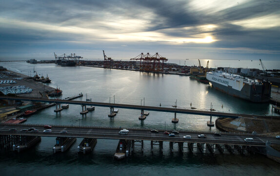 Two bridges linking a port over a body of water.