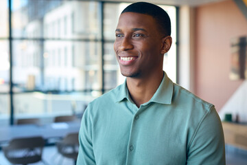 Fototapeta premium Portrait Of Smiling Businessman Standing In Empty Office 