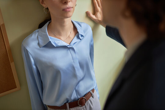 High Angle Closeup Of Male Boss Pushing Young Woman Against Wall In Office, Sexual Harassment Scene