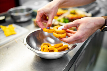 woman hand hold Onion rings on kitchen