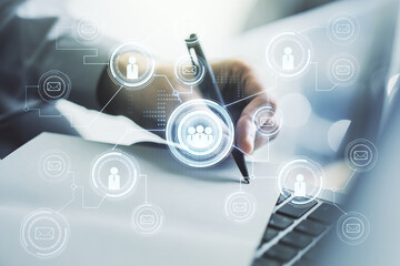 Social network concept with hand writing in notebook on background with laptop. Multiexposure