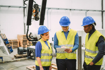 Engineers working at new AI prototype inside robotic factory - Future, job and technology concept - Mani focus on center man face