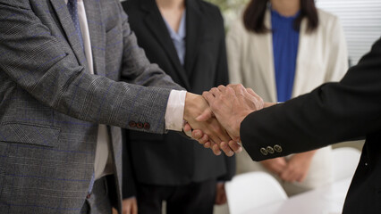 closeup with cropped shot two businesspeople having handshake with both hands after negotiation. agreement and partnership concept
