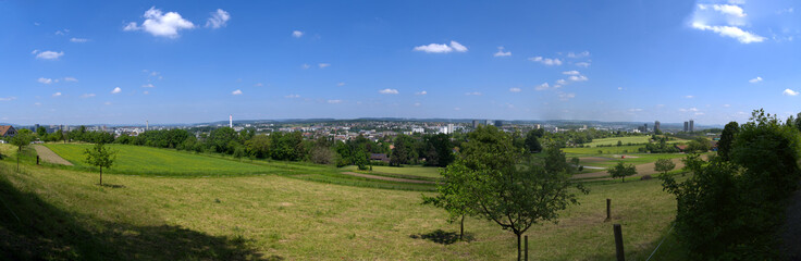 Fototapeta na wymiar Wide angle landscape with Glatt Valley and skyline of City of Zürich North in the background on a sunny spring day. Photo taken May 26th, 2023, Zurich, Switzerland.