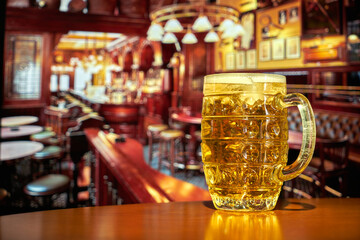 Ice cold beer under spot light in a classic English pub.