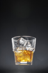 Glass of whisky on black background, copy space