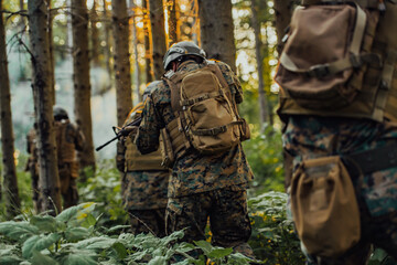 A group of modern warfare soldiers is fighting a war in dangerous remote forest areas. A group of soldiers is fighting on the enemy line with modern weapons. The concept of warfare and military