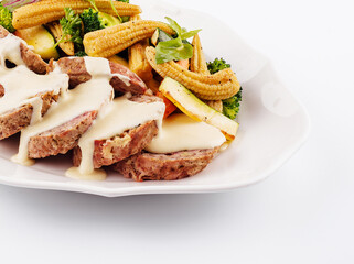 Roasted pork kebabs with broccoli and corn