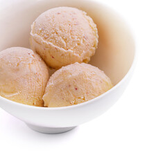Three balls of vanilla-banana ice cream in white bowl