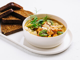 Classic hummus in a bowl with herbs