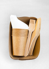 Disposable environmentally eco friendly food packaging. Brown craft paper containers, drink glasses, forks and knifes. Mockup, template